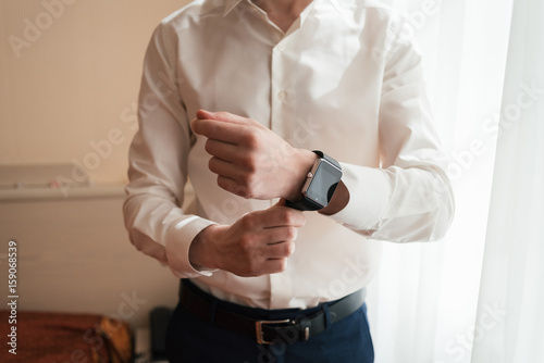 Watch on the wrist of man in white shirt