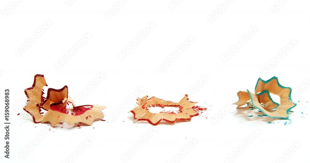Colored pencil shavings on wooden background Colored pencil shavings on wooden background