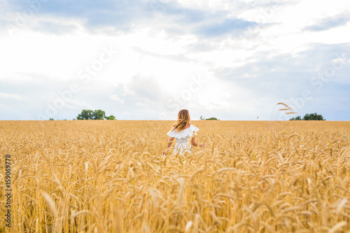 happiness  nature  summer  autumn  vacation and people concept - young woman in the field.