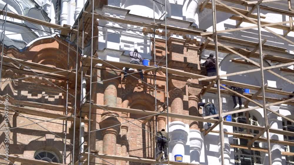 Workers Painting Wall Close Up