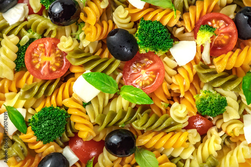 Closeup of pasta salad with cheese and vegetables