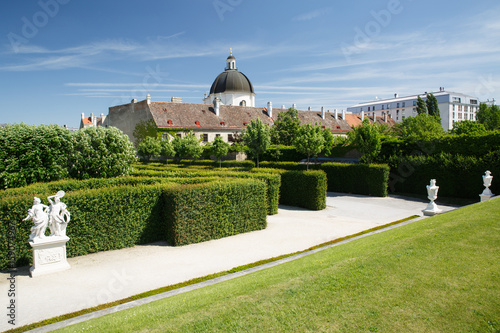 Photography green labyrinth in the garden of the Belvedere lower palace and a view of the dome of the church