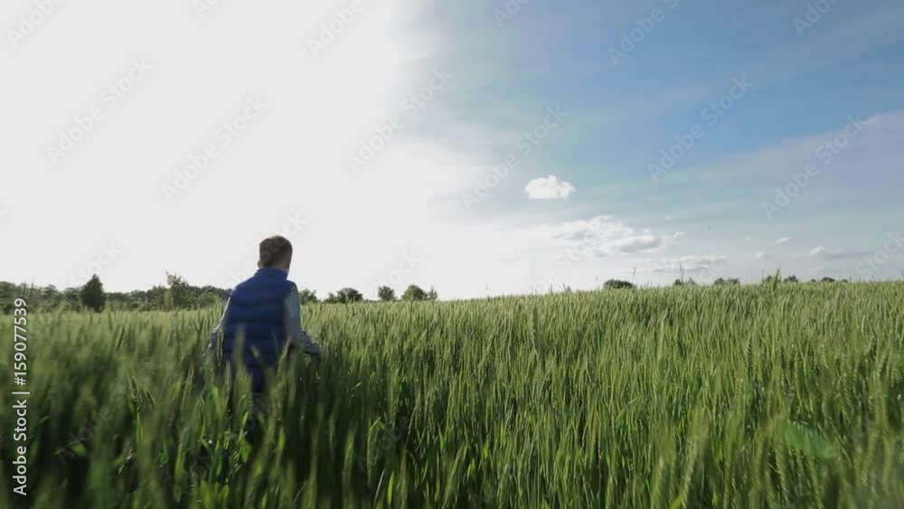 Boy Walking Through The Field Boy Walking Through The Field