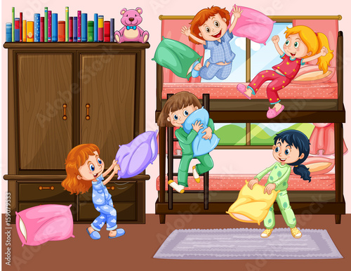 Girls having slumber party in bedroom