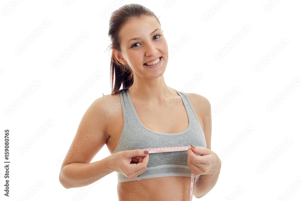 Portrait of young girl sports a close-up with the measuring tape on breast Portrait of young girl sports a close-up with the measuring tape on breast