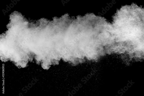 Freeze motion explosion of white dust on black background.