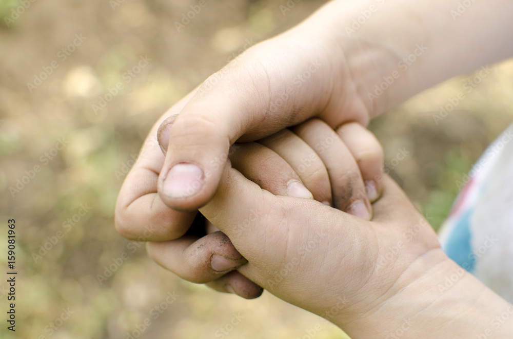 Dirty palms of the child. Dirty hands of a child in the ground. hygiene. Child cleanliness education. Baby's hands Dirty palms of the child. Dirty hands of a child in the ground. hygiene. Child cleanliness education. Baby's hands
