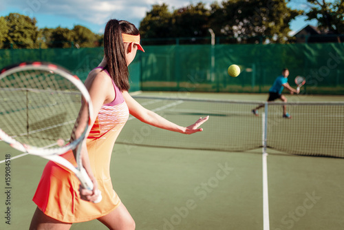Couple playing tennis on outdoor court © Nomad_Soul