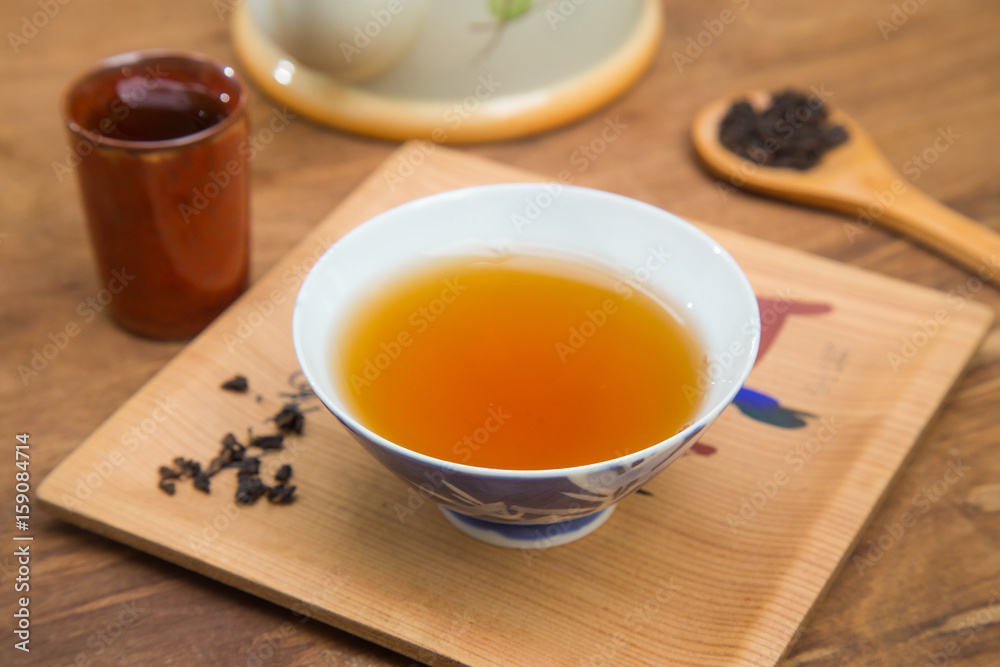Tea cup and teapot on wooden table , close-up. Tea cup and teapot on wooden table , close-up.
