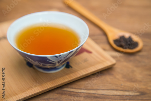 Tea cup and teapot on wooden table , close-up.