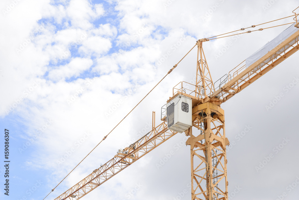 The arm of construction crane with the blue sky.Heavy construction concept.