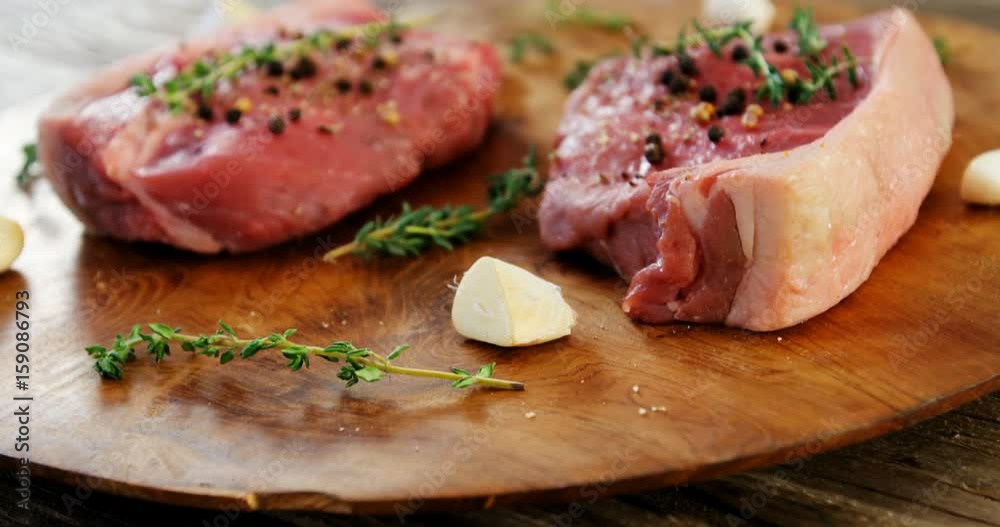 Marinated steak and ingredients on wooden board Marinated steak and ingredients on wooden board