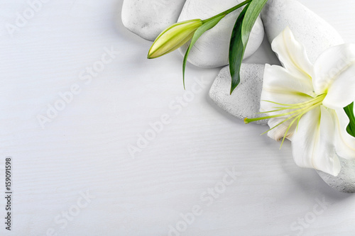 Fototapeta Naklejka Na Ścianę i Meble -  Spa stones and beautiful lily on white wooden background