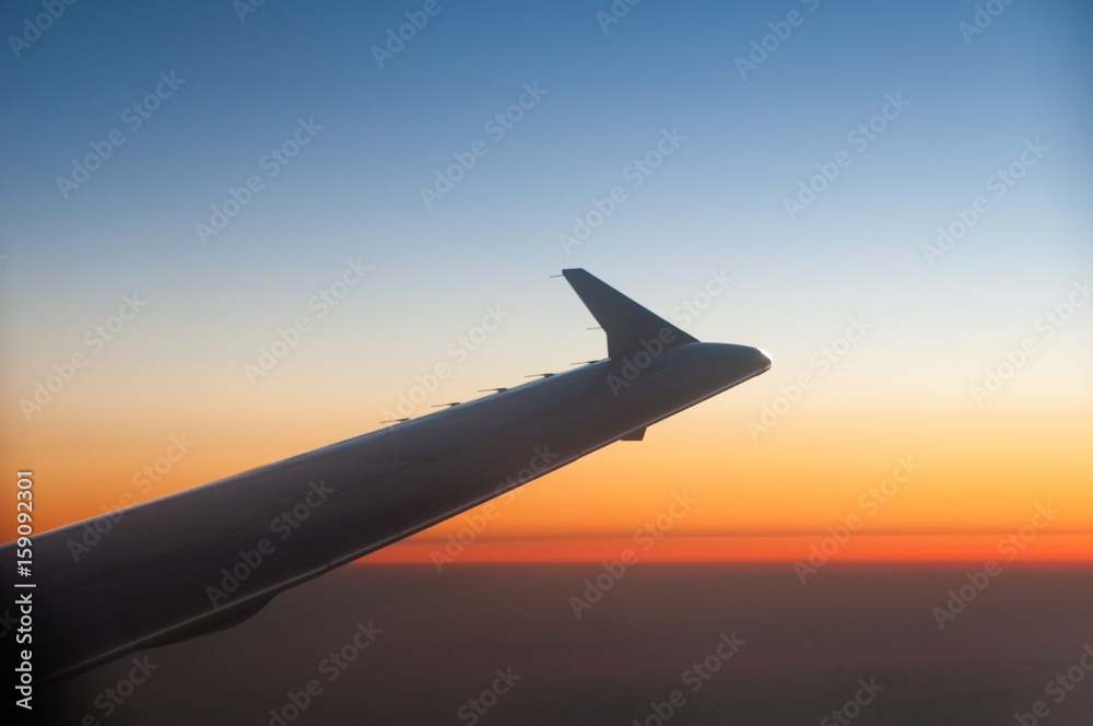 Wing of a Airplane at sunset with clouds Wing of a Airplane at sunset with clouds
