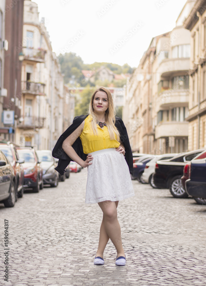 Beautiful young women posing in different clothes in urban surroundings