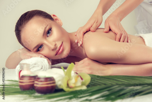 Massage and body care. Spa body massage treatment. Woman having massage in the spa salon for beautiful girl