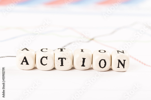 ACTION word written with wooden cubes photo