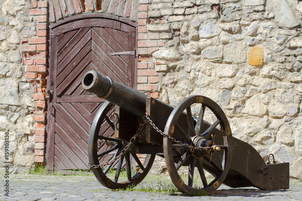 Ancient cannon in old castle in sunny summer day Ancient cannon in old castle in sunny summer day