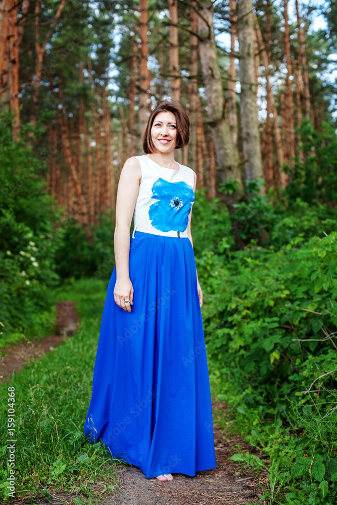 Cheerful woman walking in the forest. The concept of lifestyle, nature and travel. Cheerful woman walking in the forest. The concept of lifestyle, nature and travel.