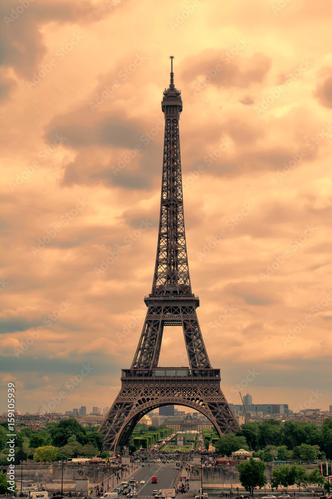 Eiffel Tower in Paris at sunset with cumulus clouds. Tour Eiffel at sunset. 