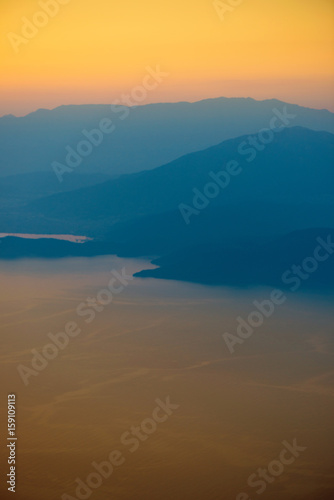 Orange sunset in the mountains. View from a height.