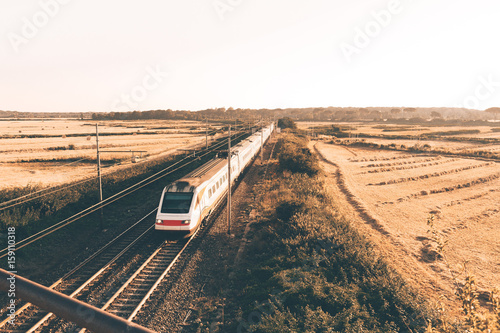 High speed train is passing under the bridge photo