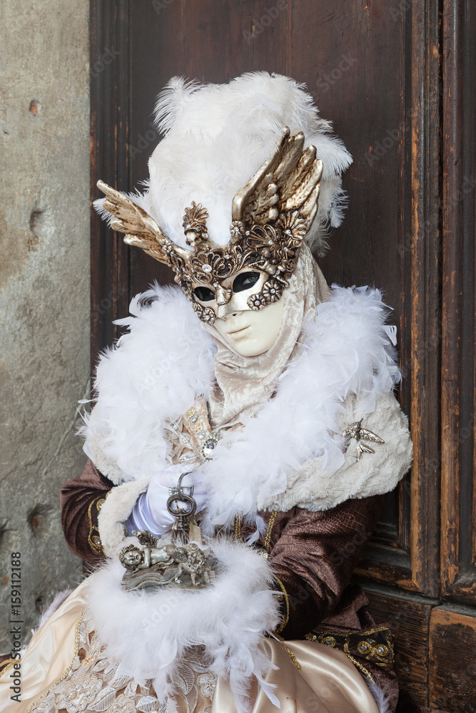 Feb 2017 Venice Carnival , Italy. Woman in winged mask and feathers with  keys and lion on book Stock Photo | Adobe Stock