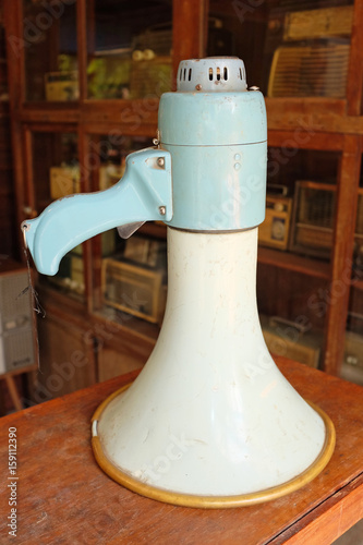 Old socialist megaphone on wood table. photo