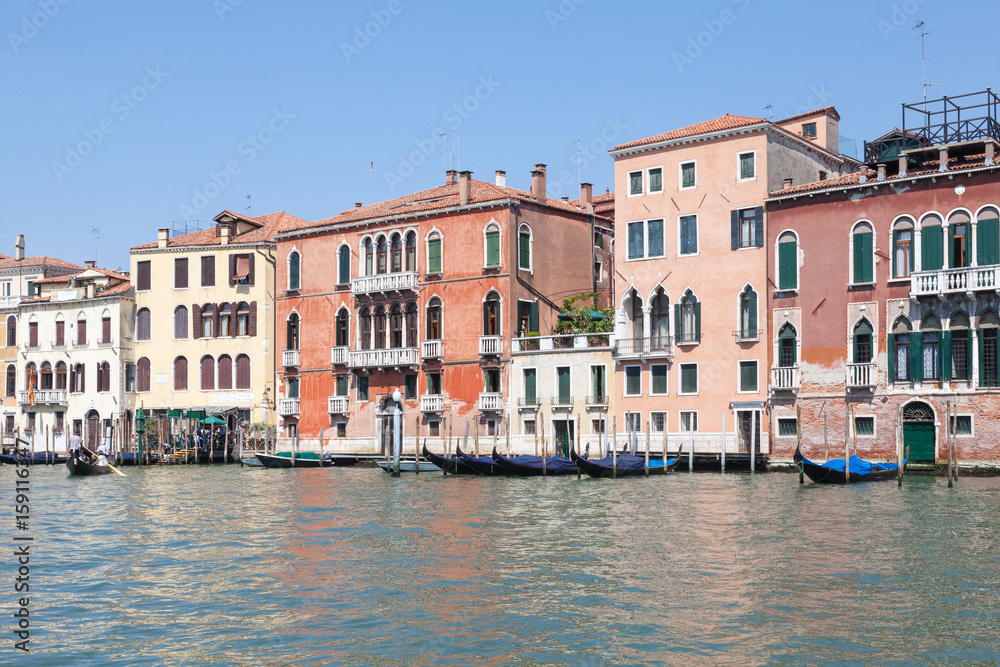 Grand Canal Venice, Veneto, Italy. The traghetto at San Toma, San Polo, crossing  in front of historic palazzos with locals and tourists
