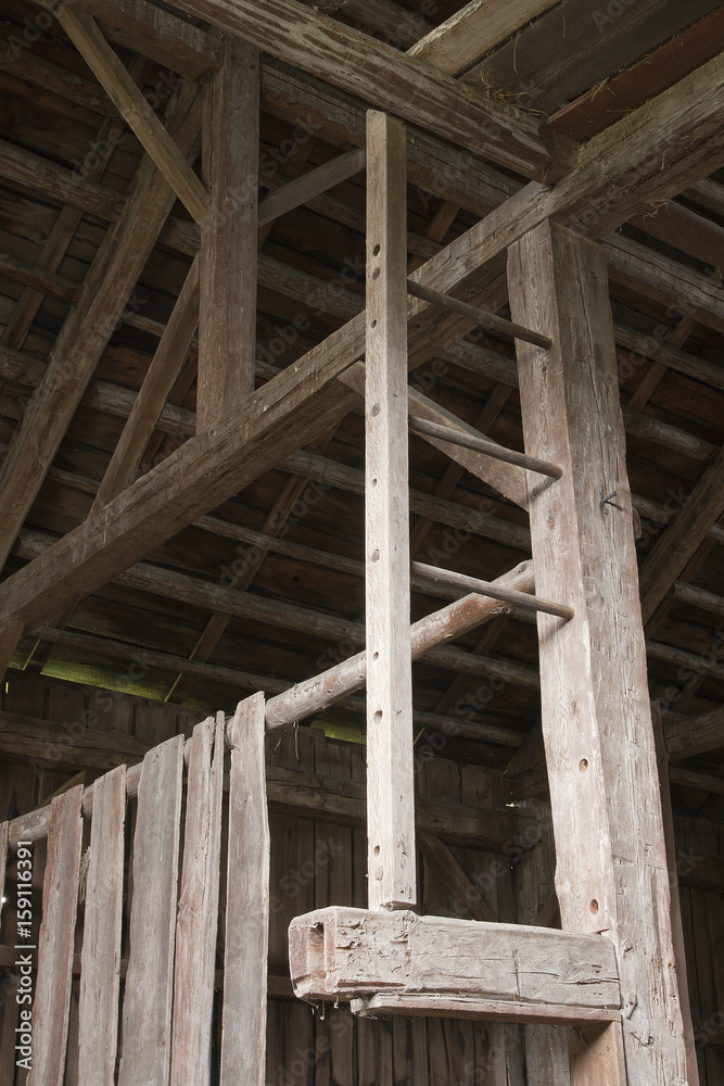 Antique wooden ladder going to the rooftop of an abandoned old wooden barn. Antique wooden ladder going to the rooftop of an abandoned old wooden barn.