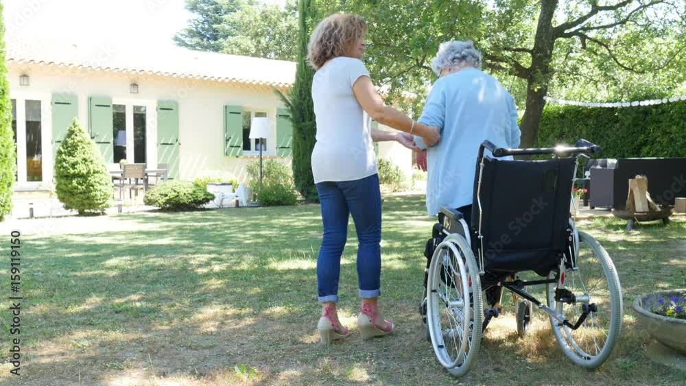 cheerful mature woman visiting her mother elderly senior female walk in retirement house hospital garden cheerful mature woman visiting her mother elderly senior female walk in retirement house hospital garden