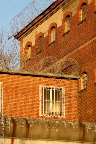The outside view of an old and abandoned jail in Berlin during sunset