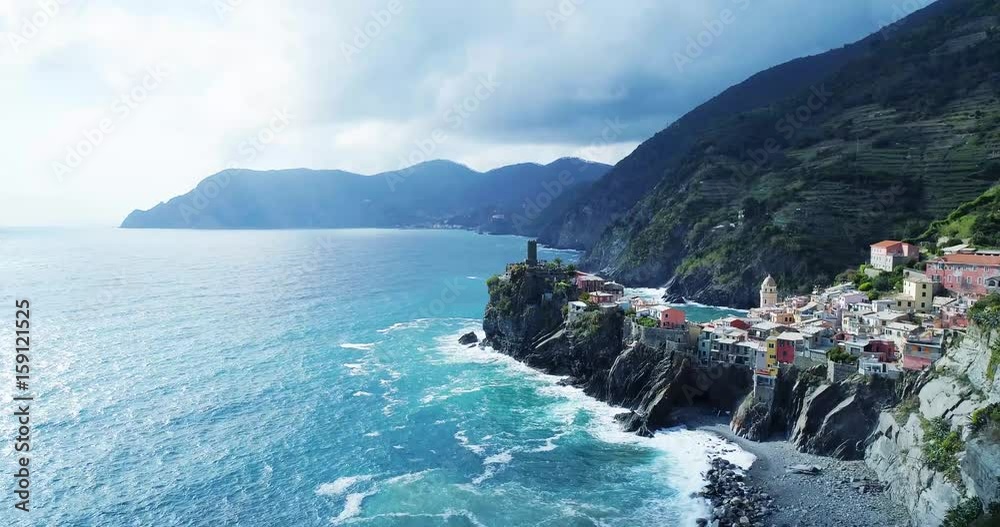 aerial view of travel landmark destination Vernazza, a small mediterranean sea town, Cinque terre National Park, Liguria, Italy. Afternoon sunny and cloud weather. 4k aerial drone forward video shot
