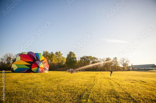 Hot air balloon being inflated early morning field