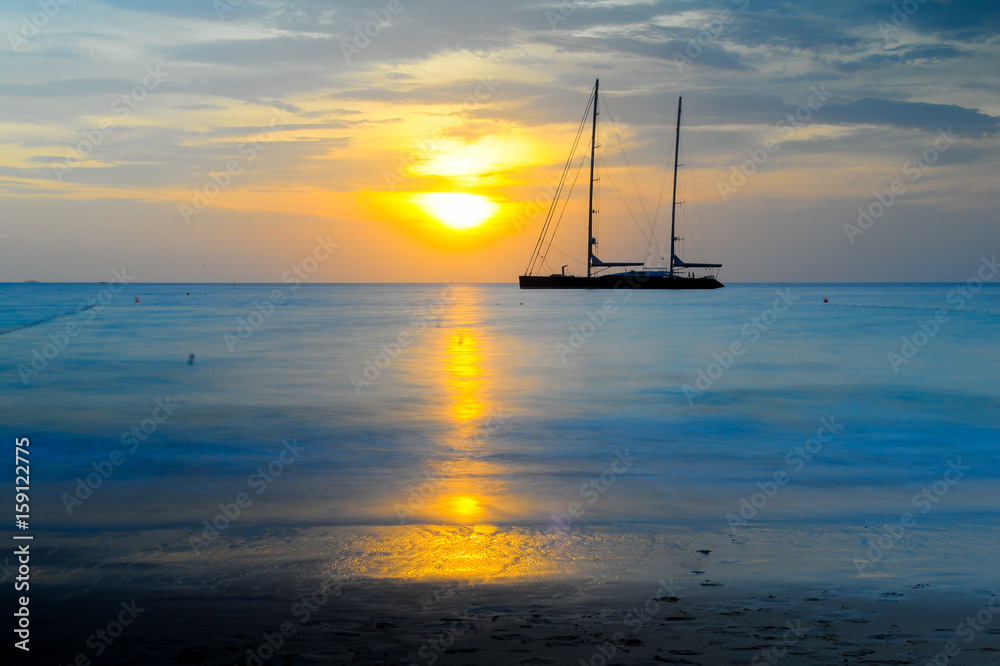 long exposure silhouette of sailing yacht in Beautiful Sunset