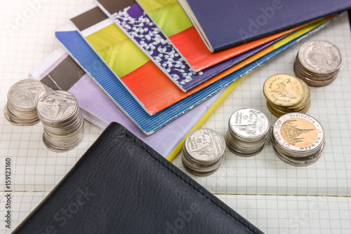 Thai money and bank saving account book on wooden table