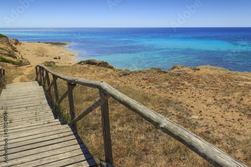 The most beautiful beaches of Italy. Campomarino dune park: fence between sea dunes,Taranto (Apulia). The protected area extends along the entire coast of the town of Maruggio.
