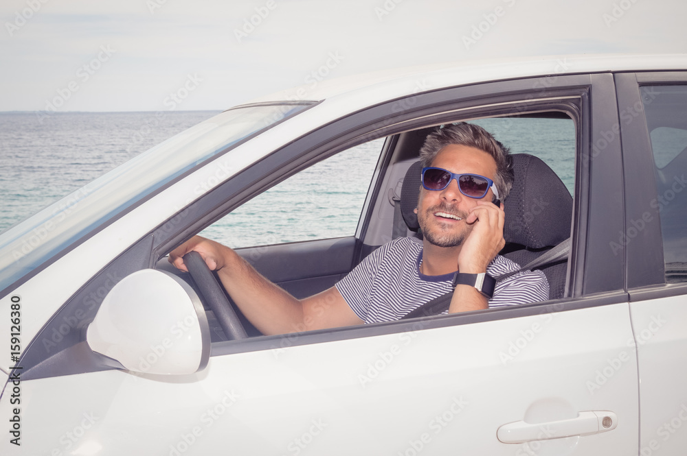 Man using smartphone while sitting in his car