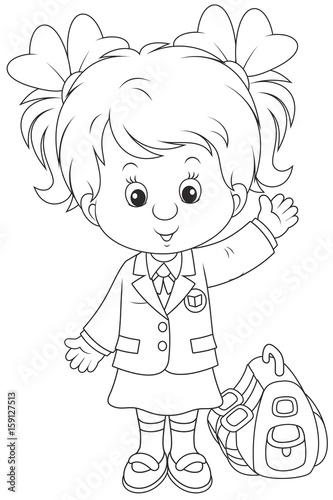 Little schoolgirl smiling, standing with her schoolbag and waving in greeting