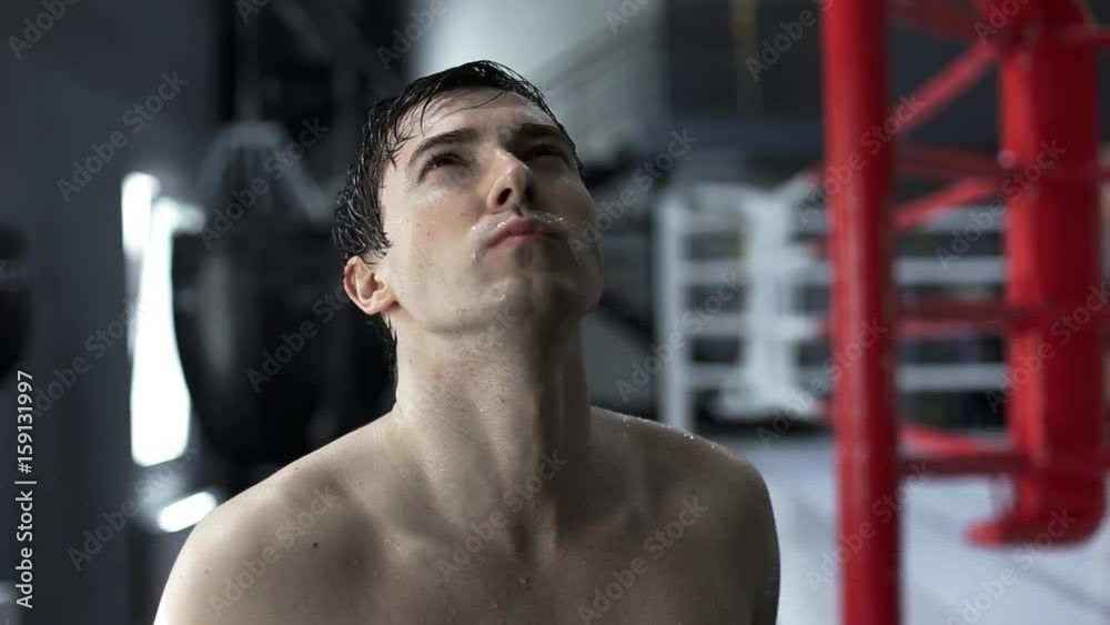 Portrait handsome man boxer after training sweat in boxing studio and looking into the camera. Tired and sweaty athlete. Portrait handsome man boxer after training sweat in boxing studio and looking into the camera. Tired and sweaty athlete.