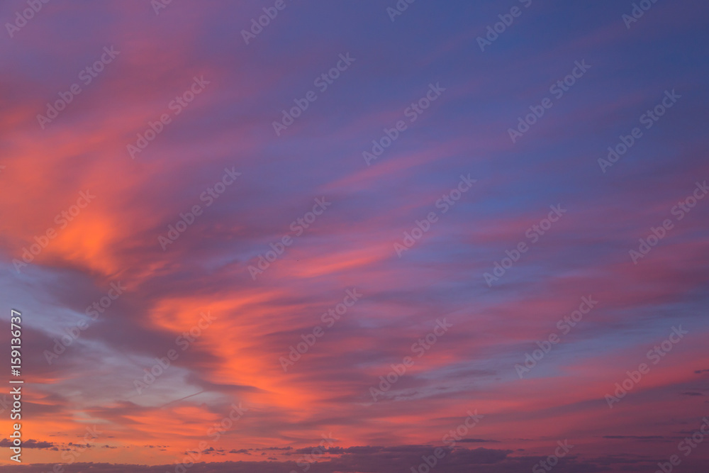 Beautiful dramatic sunrise blue sky with orange colored clouds 