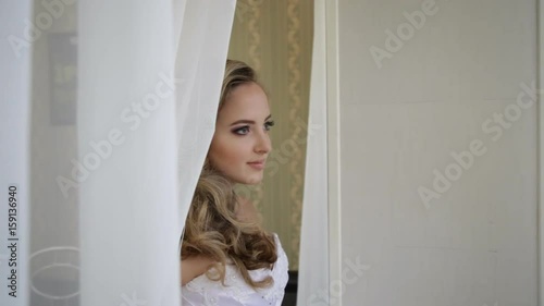 Morning of the bride. The bride goes to the window