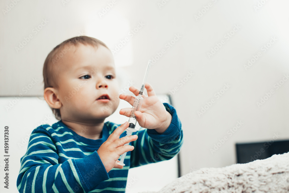 Beautiful baby with a syringe Beautiful baby with a syringe