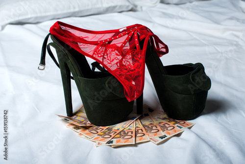 woman panties with shoes and money on a bed