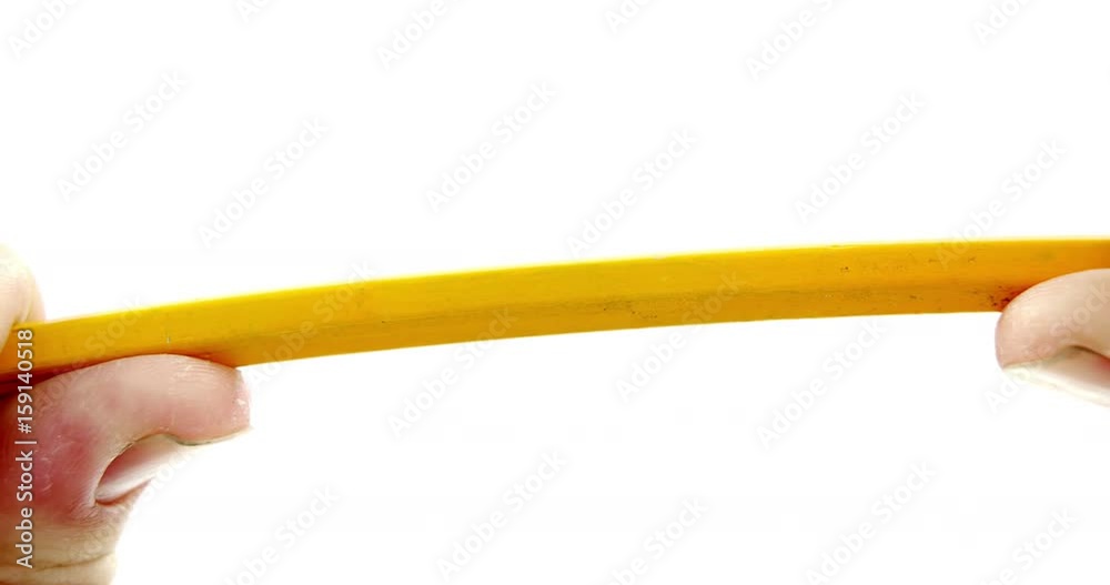 Hands breaking pencil in half on white background