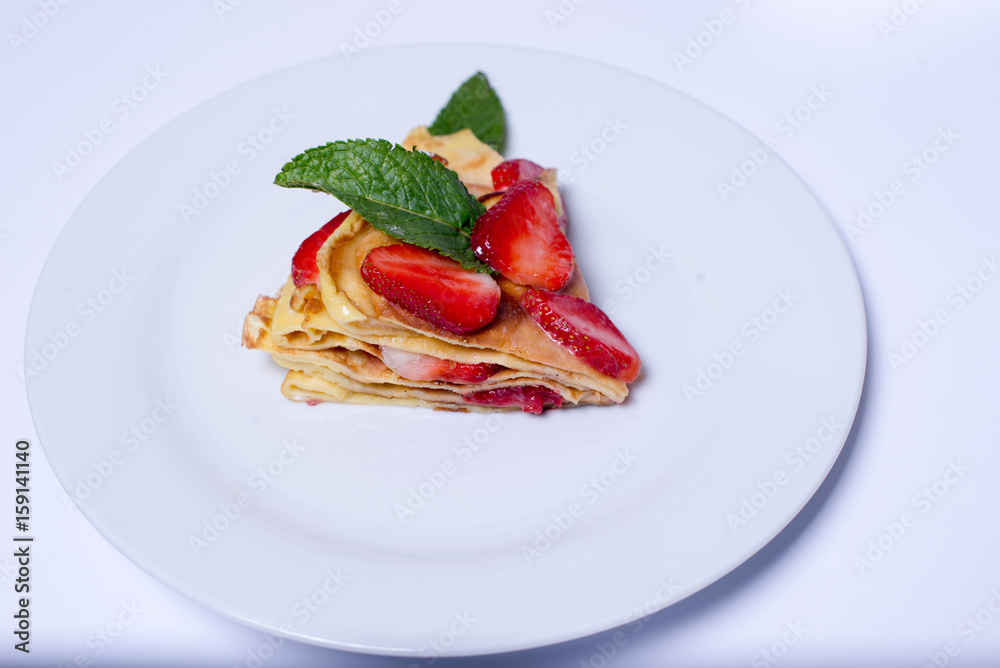 Pancakes with strawberries and mint pie with strawberries Pancakes with strawberries and mint pie with strawberries