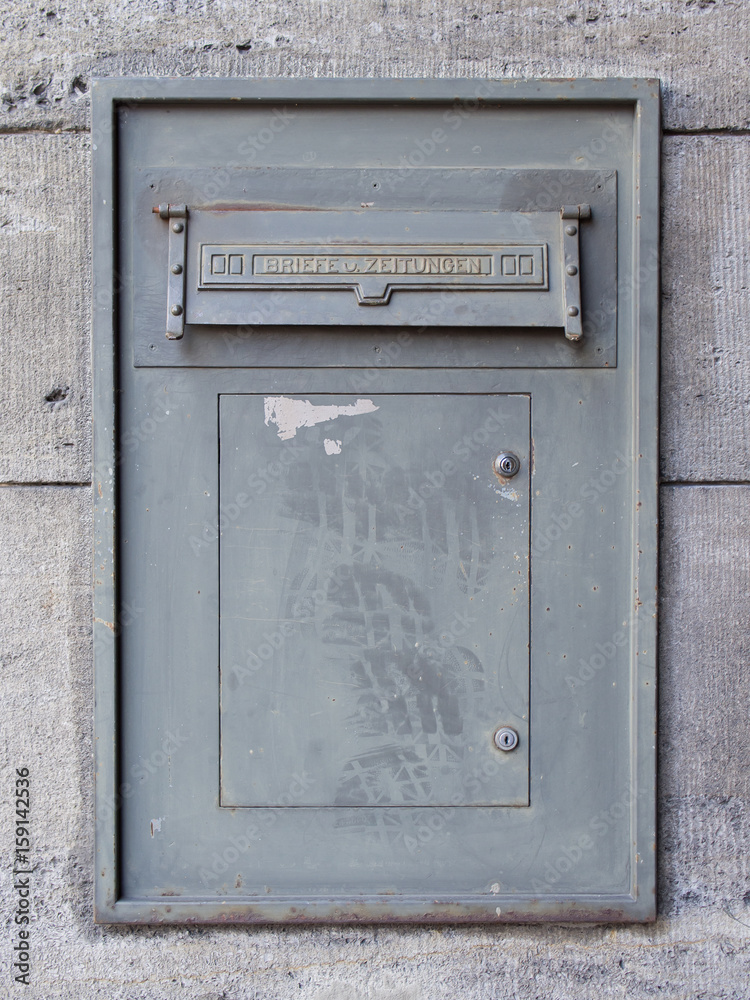 Old Dirty Metal Mailbox With Writing Letters And Newspapers In German Language Old Dirty Metal Mailbox With Writing Letters And Newspapers In German Language