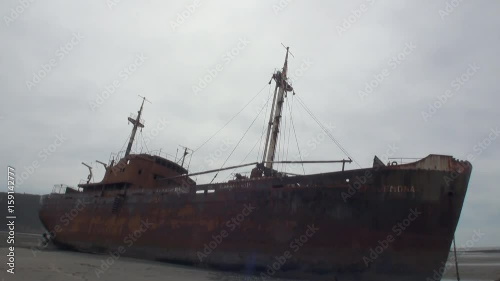 Rusty wreckage shipwreck on deserted shore beneaped dried-up ocean. Unique history place for tourism. Rusty wreckage shipwreck on deserted shore beneaped dried-up ocean. Unique history place for tourism.