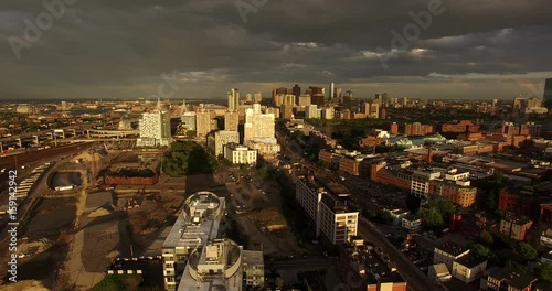 Aerial shot looking over construction site and gorgeous Boston skyline lit by setting sun photo