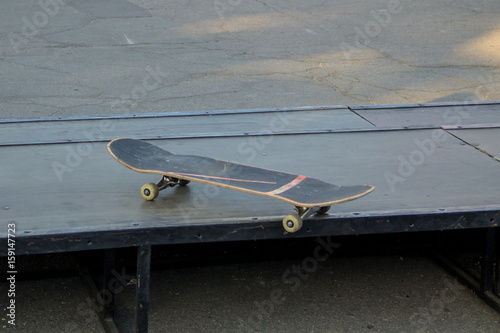 Old used skateboard at skate park